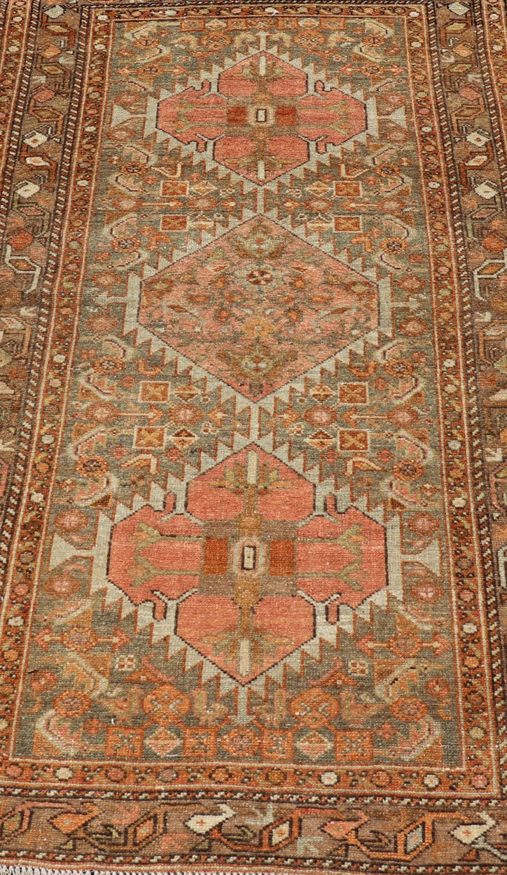Antique Persian Hamedan in Rustic Earthy Tones With Tribal Medallions This antique hamadan features three medallions in the field, surrounded by sub - geometric tribal motifs. The complementary border displays a geometric tribal design, wrapp... - Keivan Woven ArtsV21 - 1201 - 18395