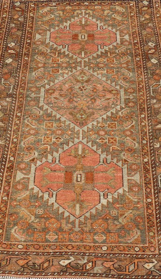 Antique Persian Hamedan in Rustic Earthy Tones With Tribal Medallions This antique hamadan features three medallions in the field, surrounded by sub - geometric tribal motifs. The complementary border displays a geometric tribal design, wrapp... - Keivan Woven ArtsV21 - 1201 - 18395