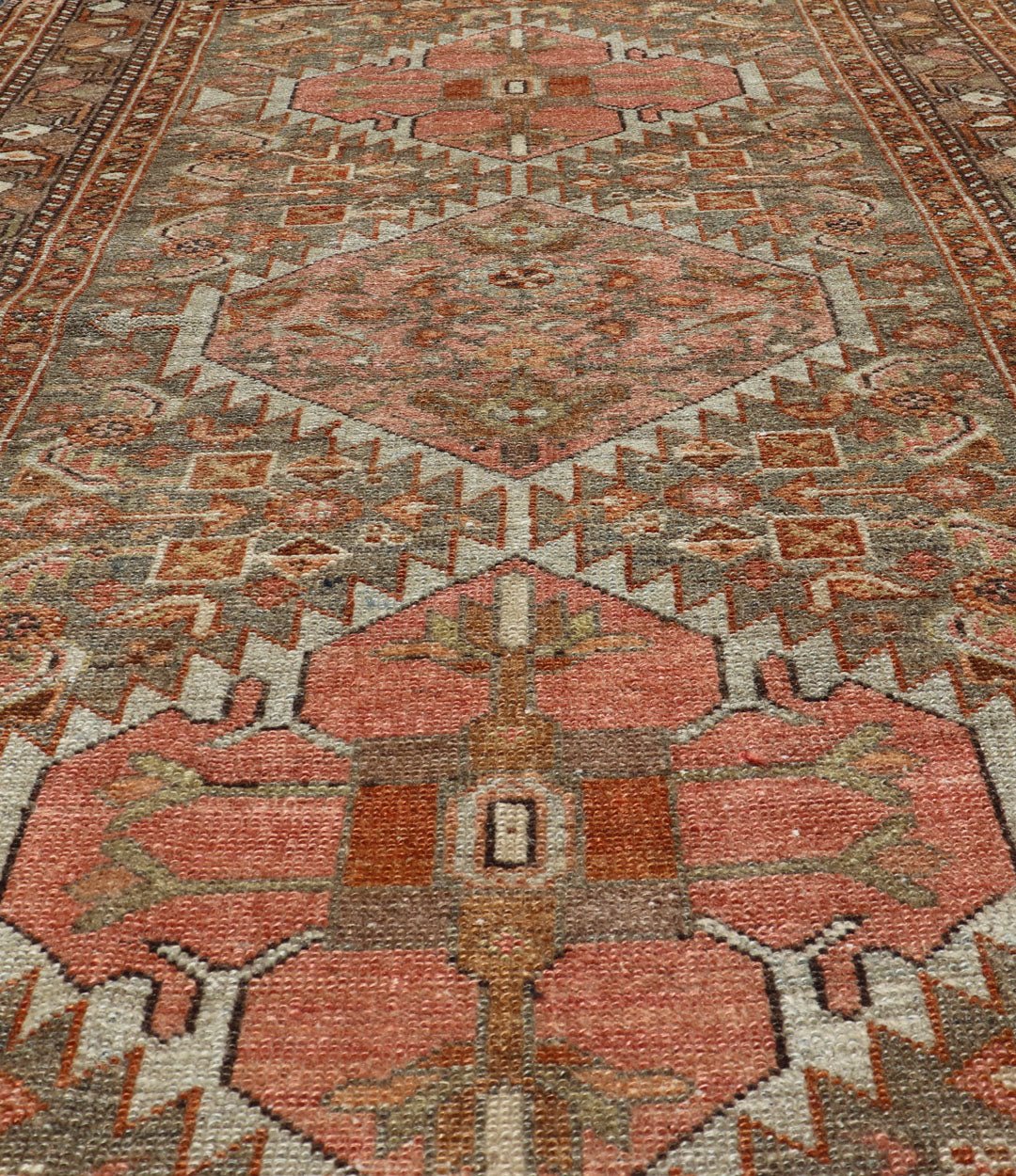 Antique Persian Hamedan in Rustic Earthy Tones With Tribal Medallions This antique hamadan features three medallions in the field, surrounded by sub - geometric tribal motifs. The complementary border displays a geometric tribal design, wrapp... - Keivan Woven ArtsV21 - 1201 - 18395