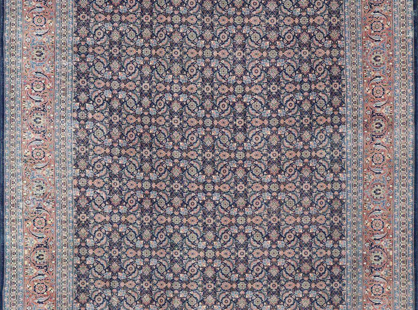 Antique Hand - Knotted Persian Tabriz with Sub - Geometric Floral Design in Wool This antique Persian Tabriz rug features an all - over, sub - geometric floral design rendered in green, coral, orange, ivory and blue shades, set upon a navy blue backgro... - Keivan Woven ArtsV21 - 1206 - 18431Rug