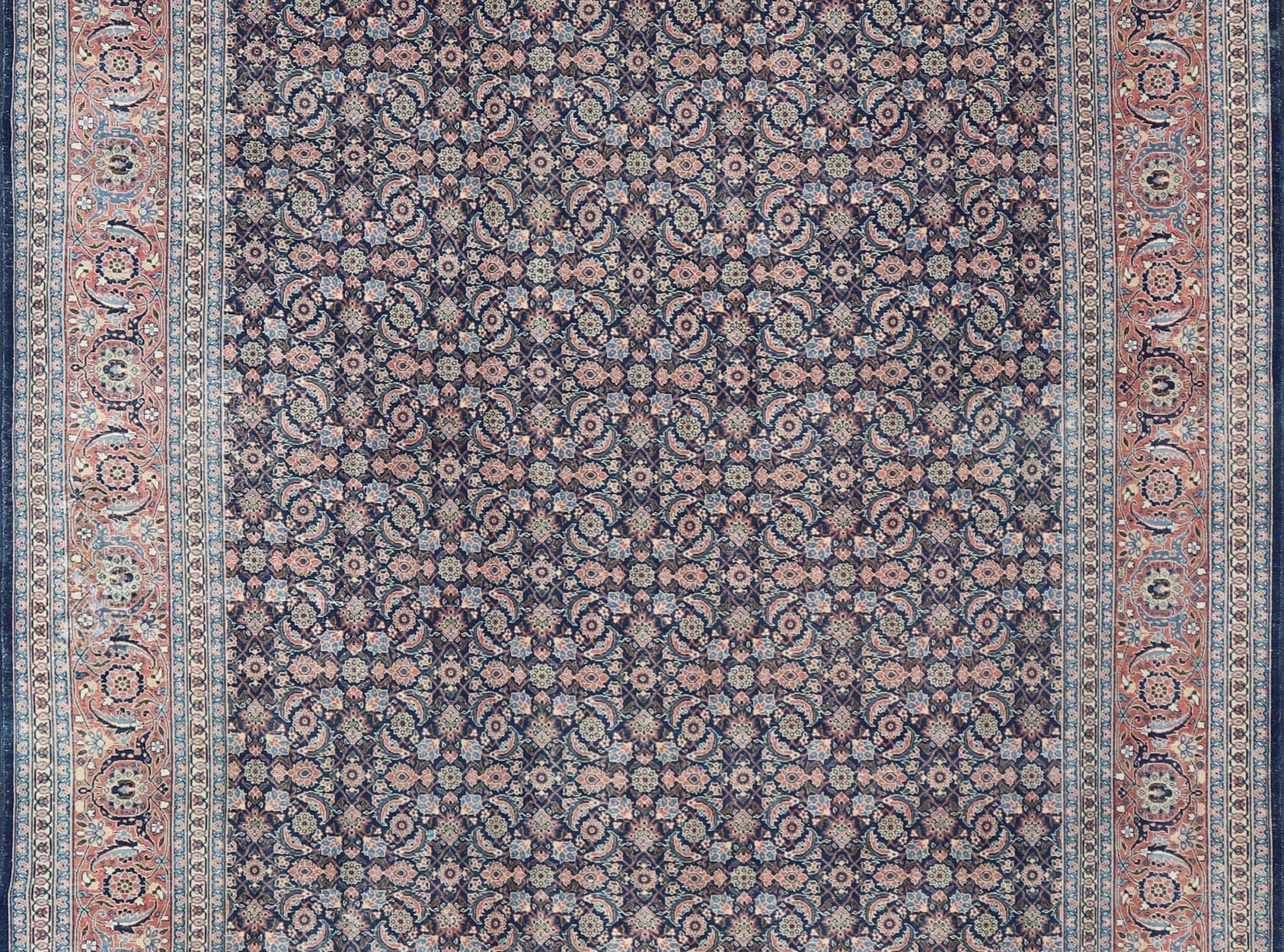 Antique Hand - Knotted Persian Tabriz with Sub - Geometric Floral Design in Wool This antique Persian Tabriz rug features an all - over, sub - geometric floral design rendered in green, coral, orange, ivory and blue shades, set upon a navy blue backgro... - Keivan Woven ArtsV21 - 1206 - 18431Rug
