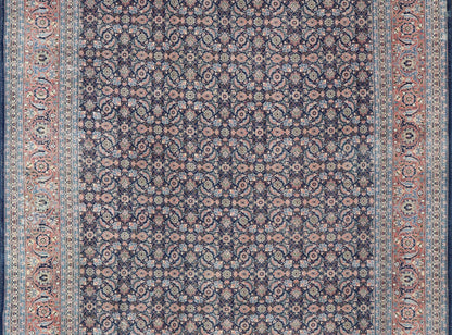 Antique Hand - Knotted Persian Tabriz with Sub - Geometric Floral Design in Wool This antique Persian Tabriz rug features an all - over, sub - geometric floral design rendered in green, coral, orange, ivory and blue shades, set upon a navy blue backgro... - Keivan Woven ArtsV21 - 1206 - 18431Rug