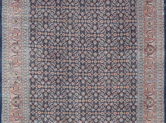 Antique Hand - Knotted Persian Tabriz with Sub - Geometric Floral Design in Wool This antique Persian Tabriz rug features an all - over, sub - geometric floral design rendered in green, coral, orange, ivory and blue shades, set upon a navy blue backgro... - Keivan Woven ArtsV21 - 1206 - 18431Rug