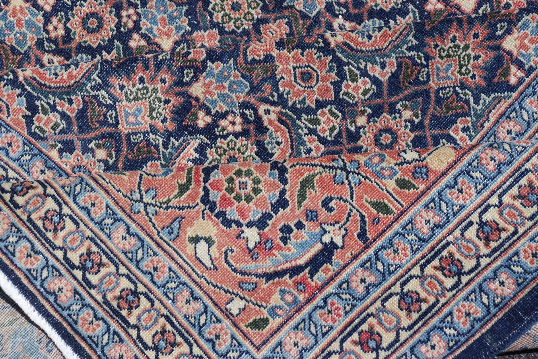 Antique Hand - Knotted Persian Tabriz with Sub - Geometric Floral Design in Wool This antique Persian Tabriz rug features an all - over, sub - geometric floral design rendered in green, coral, orange, ivory and blue shades, set upon a navy blue backgro... - Keivan Woven ArtsV21 - 1206 - 18431