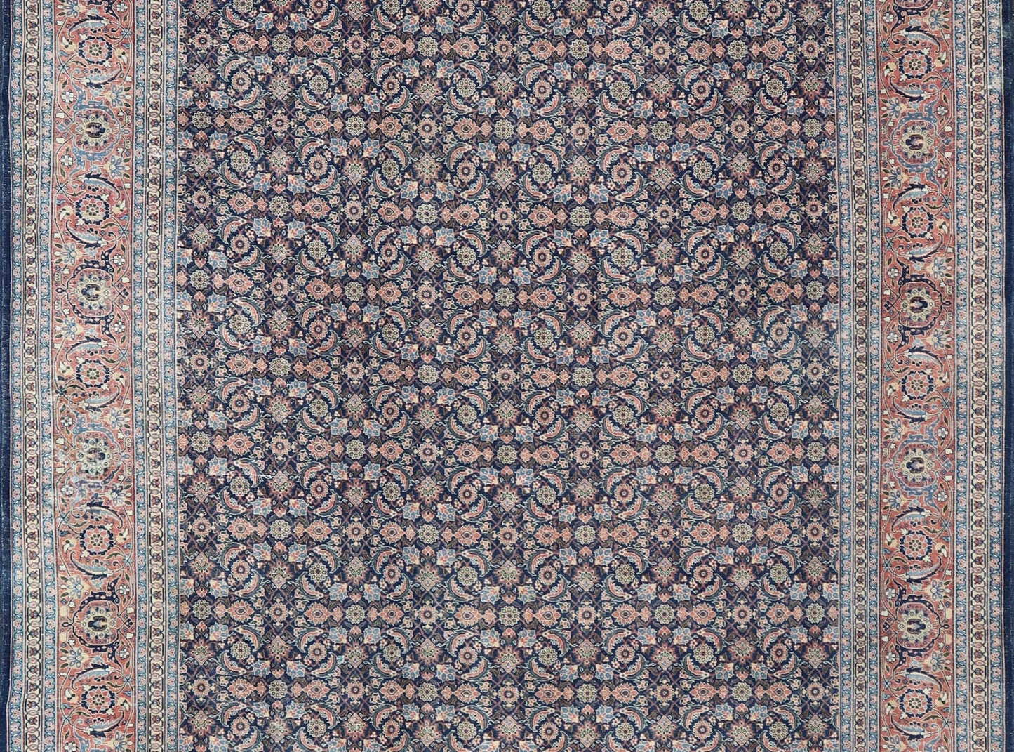 Antique Hand - Knotted Persian Tabriz with Sub - Geometric Floral Design in Wool This antique Persian Tabriz rug features an all - over, sub - geometric floral design rendered in green, coral, orange, ivory and blue shades, set upon a navy blue backgro... - Keivan Woven ArtsV21 - 1206 - 18431