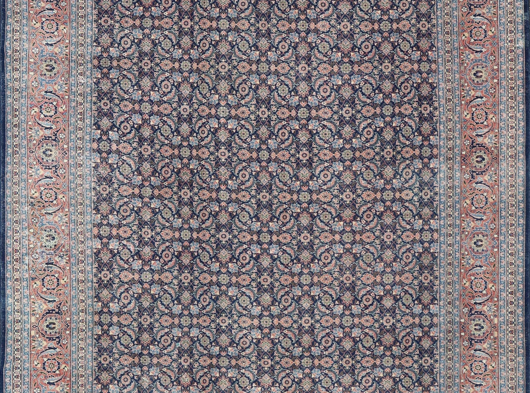 Antique Hand - Knotted Persian Tabriz with Sub - Geometric Floral Design in Wool This antique Persian Tabriz rug features an all - over, sub - geometric floral design rendered in green, coral, orange, ivory and blue shades, set upon a navy blue backgro... - Keivan Woven ArtsV21 - 1206 - 18431