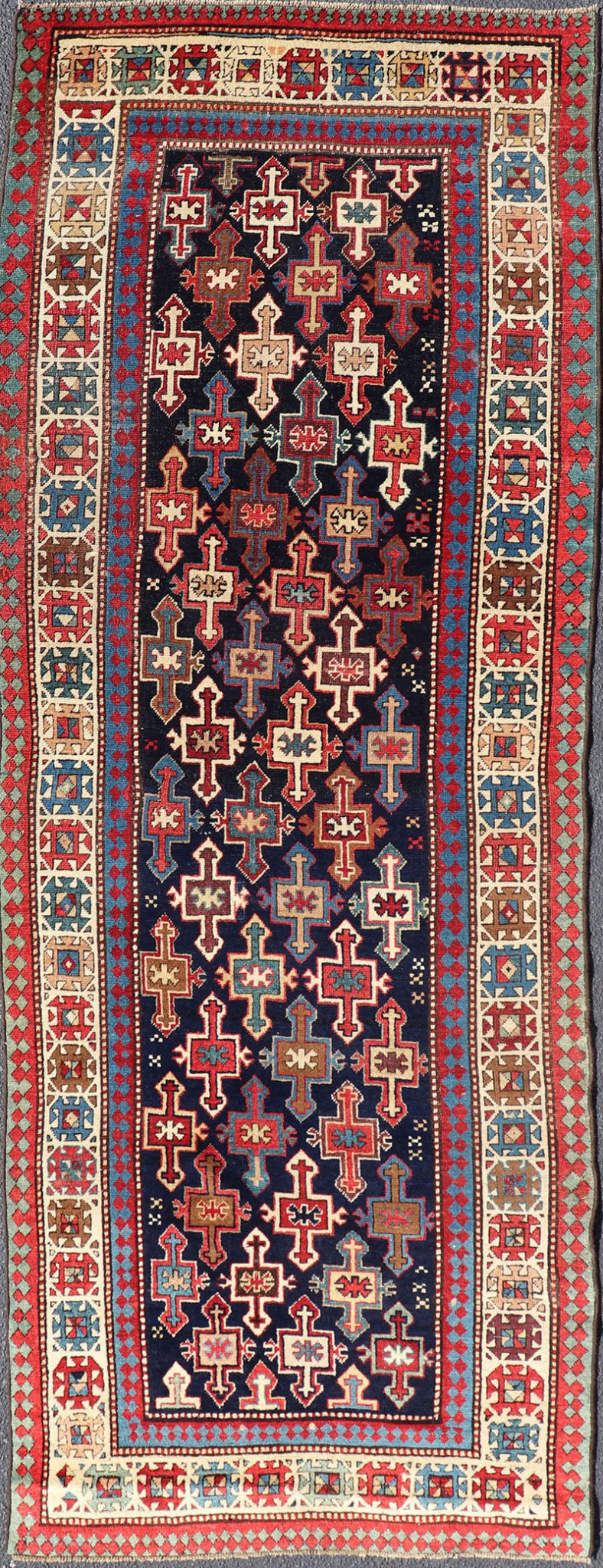 Late 19th Century Kazak Runner with Geometric Design in Tribal Crosses. Country of Origin: Caucasus Type: Kazak Design: All - Over, Sub - Geometric, Medallion Keivan Woven Arts; rug V21 - 1211 Measures; 3'3 x 9'1 This piece was hand - knotted in Caucasu... - Keivan Woven ArtsV21 - 1211 - 18485Rug