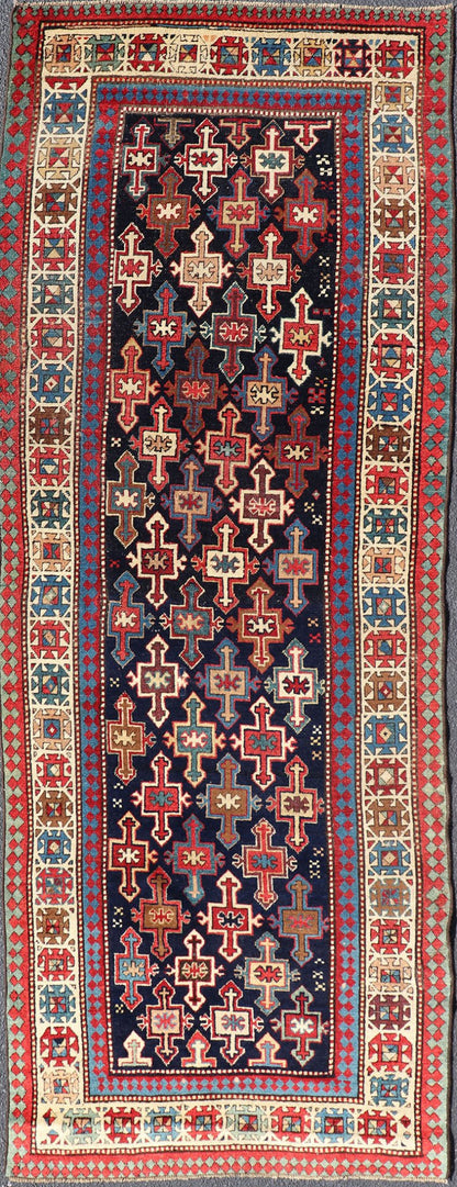 Late 19th Century Kazak Runner with Geometric Design in Tribal Crosses. Country of Origin: Caucasus Type: Kazak Design: All - Over, Sub - Geometric, Medallion Keivan Woven Arts; rug V21 - 1211 Measures; 3'3 x 9'1 This piece was hand - knotted in Caucasu... - Keivan Woven ArtsV21 - 1211 - 18485Rug
