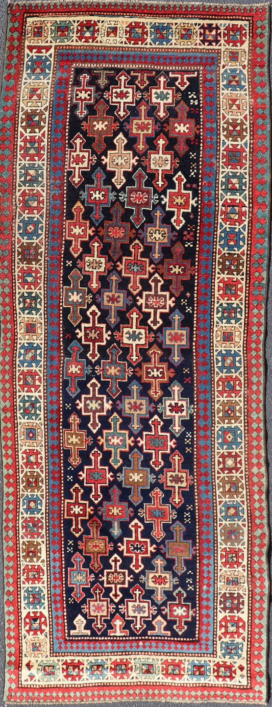 Late 19th Century Kazak Runner with Geometric Design in Tribal Crosses. Country of Origin: Caucasus Type: Kazak Design: All - Over, Sub - Geometric, Medallion Keivan Woven Arts; rug V21 - 1211 Measures; 3'3 x 9'1 This piece was hand - knotted in Caucasu... - Keivan Woven ArtsV21 - 1211 - 18485Rug