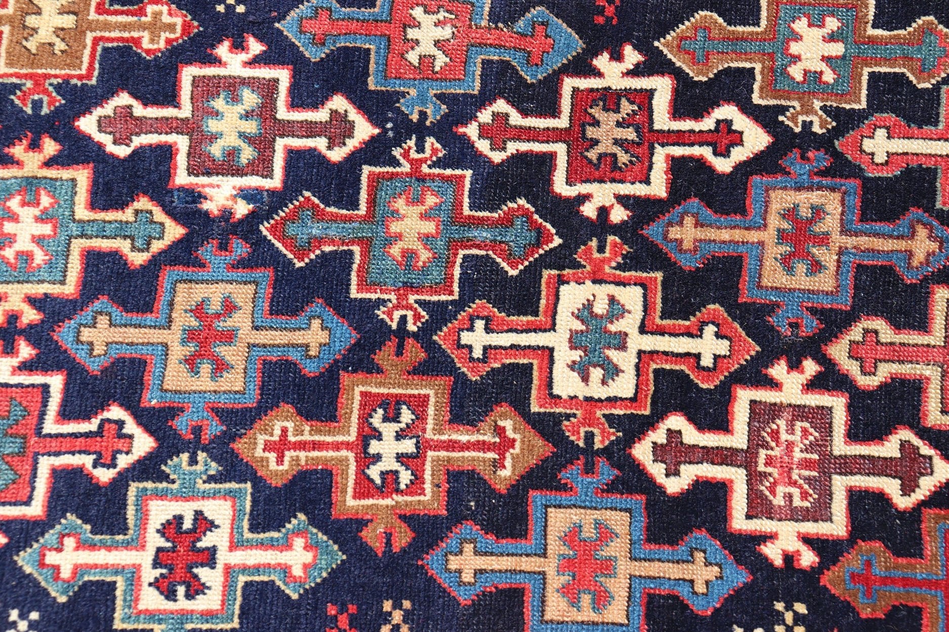 Late 19th Century Kazak Runner with Geometric Design in Tribal Crosses. Country of Origin: Caucasus Type: Kazak Design: All - Over, Sub - Geometric, Medallion Keivan Woven Arts; rug V21 - 1211 Measures; 3'3 x 9'1 This piece was hand - knotted in Caucasu... - Keivan Woven ArtsV21 - 1211 - 18485Rug