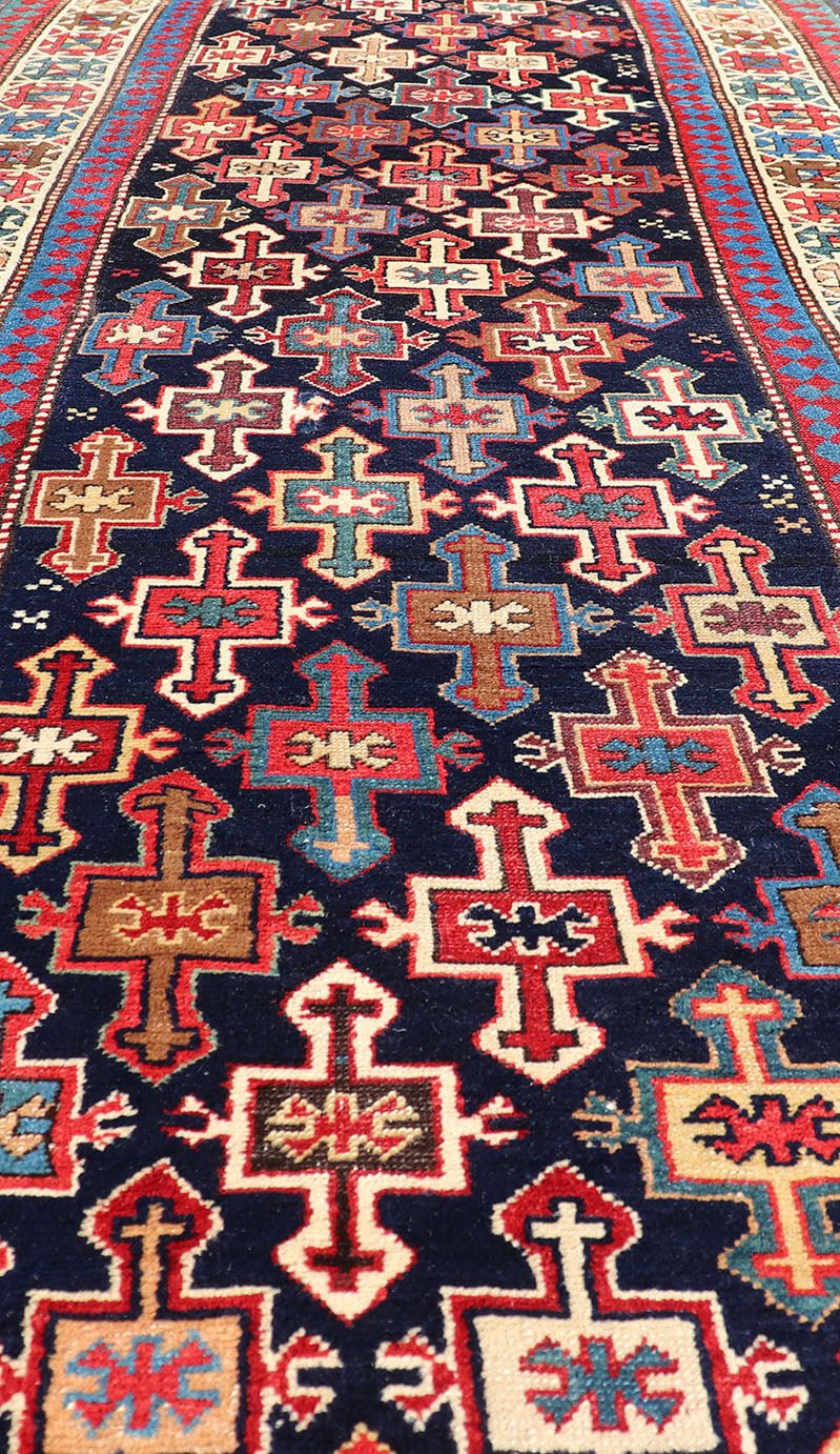 Late 19th Century Kazak Runner with Geometric Design in Tribal Crosses. Country of Origin: Caucasus Type: Kazak Design: All - Over, Sub - Geometric, Medallion Keivan Woven Arts; rug V21 - 1211 Measures; 3'3 x 9'1 This piece was hand - knotted in Caucasu... - Keivan Woven ArtsV21 - 1211 - 18485Rug