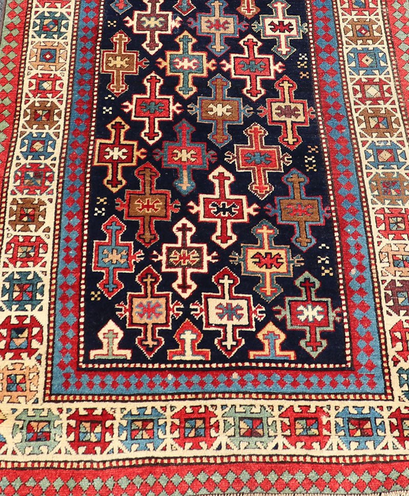 Late 19th Century Kazak Runner with Geometric Design in Tribal Crosses. Country of Origin: Caucasus Type: Kazak Design: All - Over, Sub - Geometric, Medallion Keivan Woven Arts; rug V21 - 1211 Measures; 3'3 x 9'1 This piece was hand - knotted in Caucasu... - Keivan Woven ArtsV21 - 1211 - 18485Rug