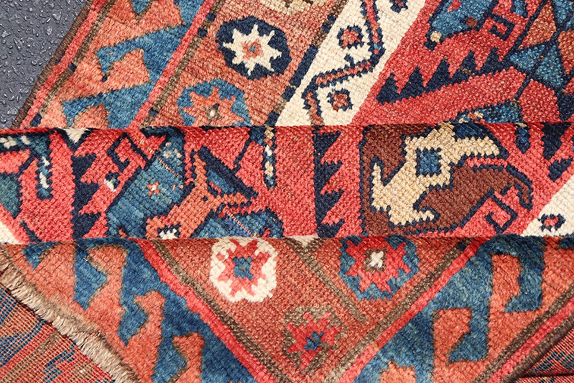 Late 19th Century Kazak Runner featuring All - Over, Geometric Tribal Motifs This late 19th - century treasure is rendered in red, brick, blue, ivory, sandy taupe, and small accents in salmon. The multi - tier border displays tribal - like patterns and sta... - Keivan Woven ArtsV21 - 1213 - 18493Rug