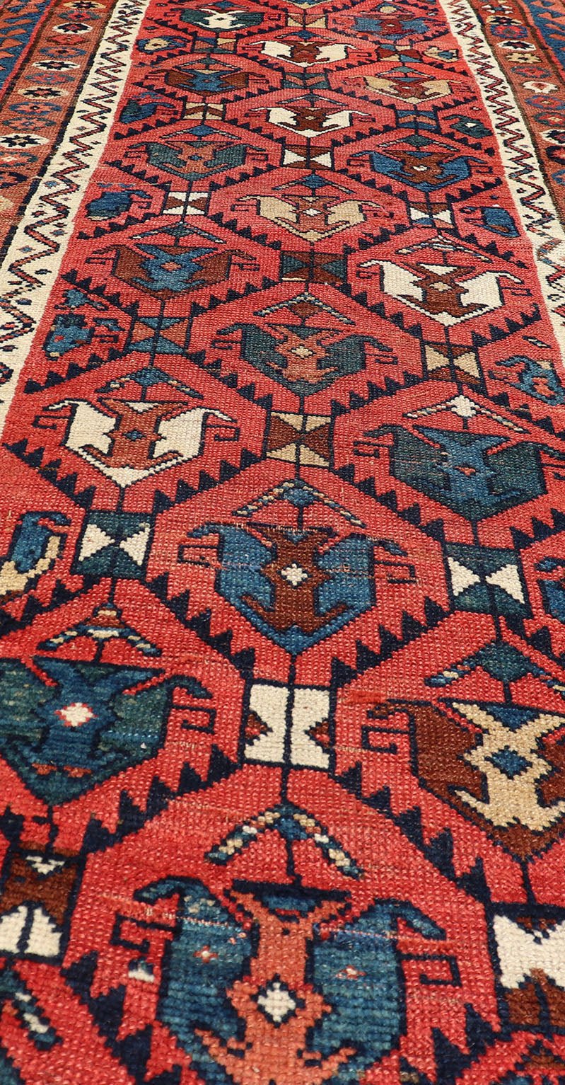 Late 19th Century Kazak Runner featuring All - Over, Geometric Tribal Motifs This late 19th - century treasure is rendered in red, brick, blue, ivory, sandy taupe, and small accents in salmon. The multi - tier border displays tribal - like patterns and sta... - Keivan Woven ArtsV21 - 1213 - 18493Rug