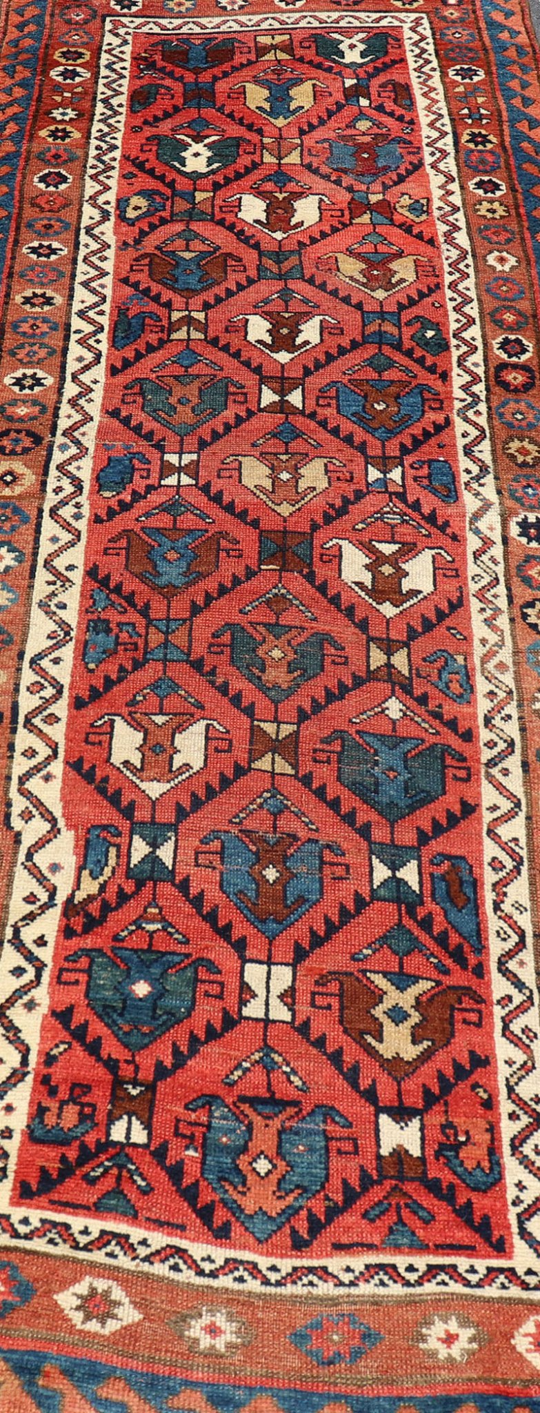 Late 19th Century Kazak Runner featuring All - Over, Geometric Tribal Motifs This late 19th - century treasure is rendered in red, brick, blue, ivory, sandy taupe, and small accents in salmon. The multi - tier border displays tribal - like patterns and sta... - Keivan Woven ArtsV21 - 1213 - 18493Rug