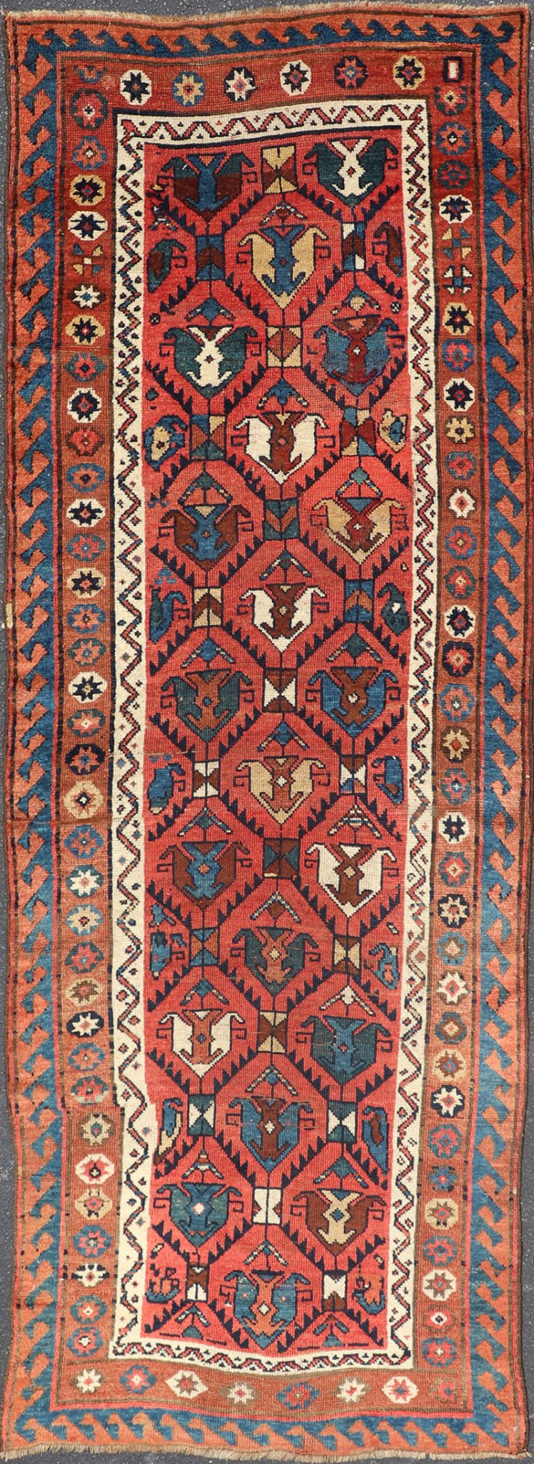 Late 19th Century Kazak Runner featuring All - Over, Geometric Tribal Motifs This late 19th - century treasure is rendered in red, brick, blue, ivory, sandy taupe, and small accents in salmon. The multi - tier border displays tribal - like patterns and sta... - Keivan Woven ArtsV21 - 1213 - 18493Rug