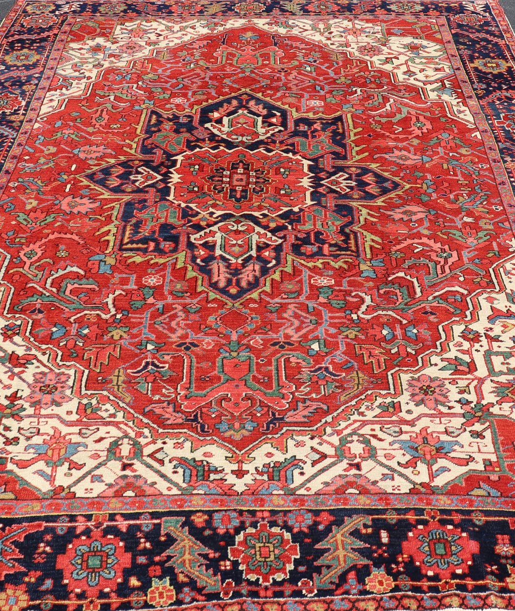 Antique Heriz Carpet with Stylized Central Medallion Set on Tomato Red Field. Antique Heriz Carpet with Stylized Central Medallion Set on Tomato Red Field. Keivan Woven Arts / Rug / VR - 8759 / country of origin / type: Persian / Serapi, circa ea... - Keivan Woven ArtsVR - 8759 - 1 - 24745Rugs