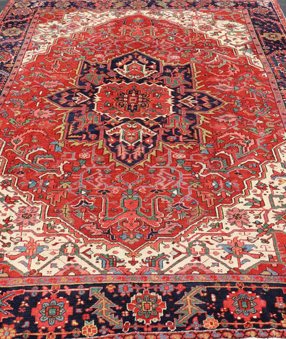 Antique Heriz Carpet with Stylized Central Medallion Set on Tomato Red Field. Antique Heriz Carpet with Stylized Central Medallion Set on Tomato Red Field. Keivan Woven Arts / Rug / VR - 8759 / country of origin / type: Persian / Serapi, circa ea... - Keivan Woven ArtsVR - 8759 - 1 - 24745Rugs