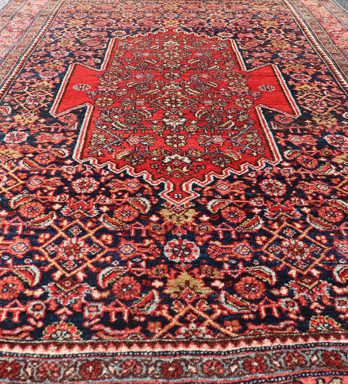 Antique Persian Bidjar Medallion Designed Carpet with of Blue's, Red, and Pink Measures: 4'5 x 6'7 The rug has a central medallion, surrounded by an intricate floral Herati design. The border utilizes softer colors of pink, blue and yel... - Keivan Woven ArtsW22 - 0102 - 18577