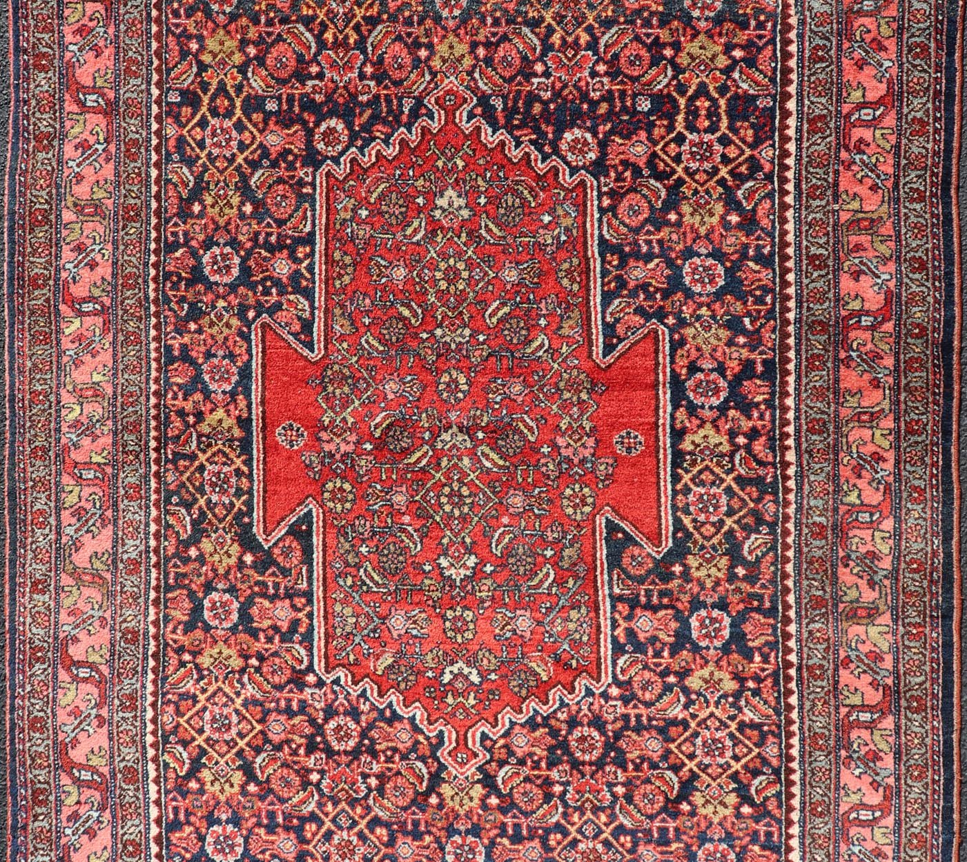Antique Persian Bidjar Medallion Designed Carpet with of Blue's, Red, and Pink Measures: 4'5 x 6'7 The rug has a central medallion, surrounded by an intricate floral Herati design. The border utilizes softer colors of pink, blue and yel... - Keivan Woven ArtsW22 - 0102 - 18577