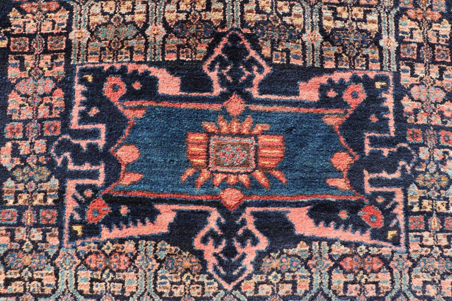 Antique Bibiakabad Rug with Layered Medallion and Geometric Design in Background Blue, dark blue, pink, and tan Bibiakabad antique rug Persian, Keivan Woven Arts / rug W22 - 0103, country of origin / type: Iran / Bibiakabad , circa 1920. ... - Keivan Woven ArtsW22 - 0103 - 18583