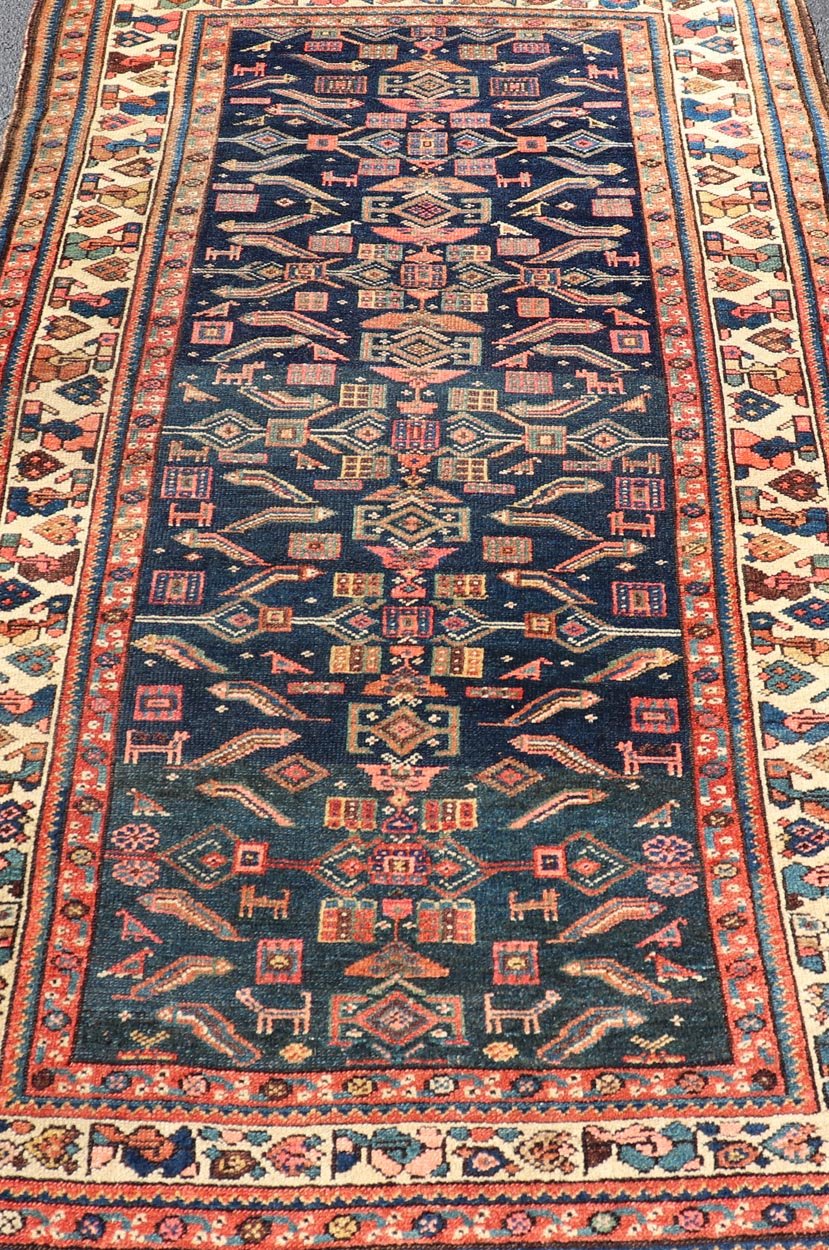 Antique Kurdish Rug With All - Over Geometric Design on a Blue Background. Country of Origin: Iran; Type: Kurdish; Design: Tribal, Floral, Tribal Motif; Keivan Woven Arts: Rug X23 - 0103. Measures: 4'6 x 8'0 This antique rug from Persia features ge... - Keivan Woven ArtsX23 - 0103 - 24211Rug
