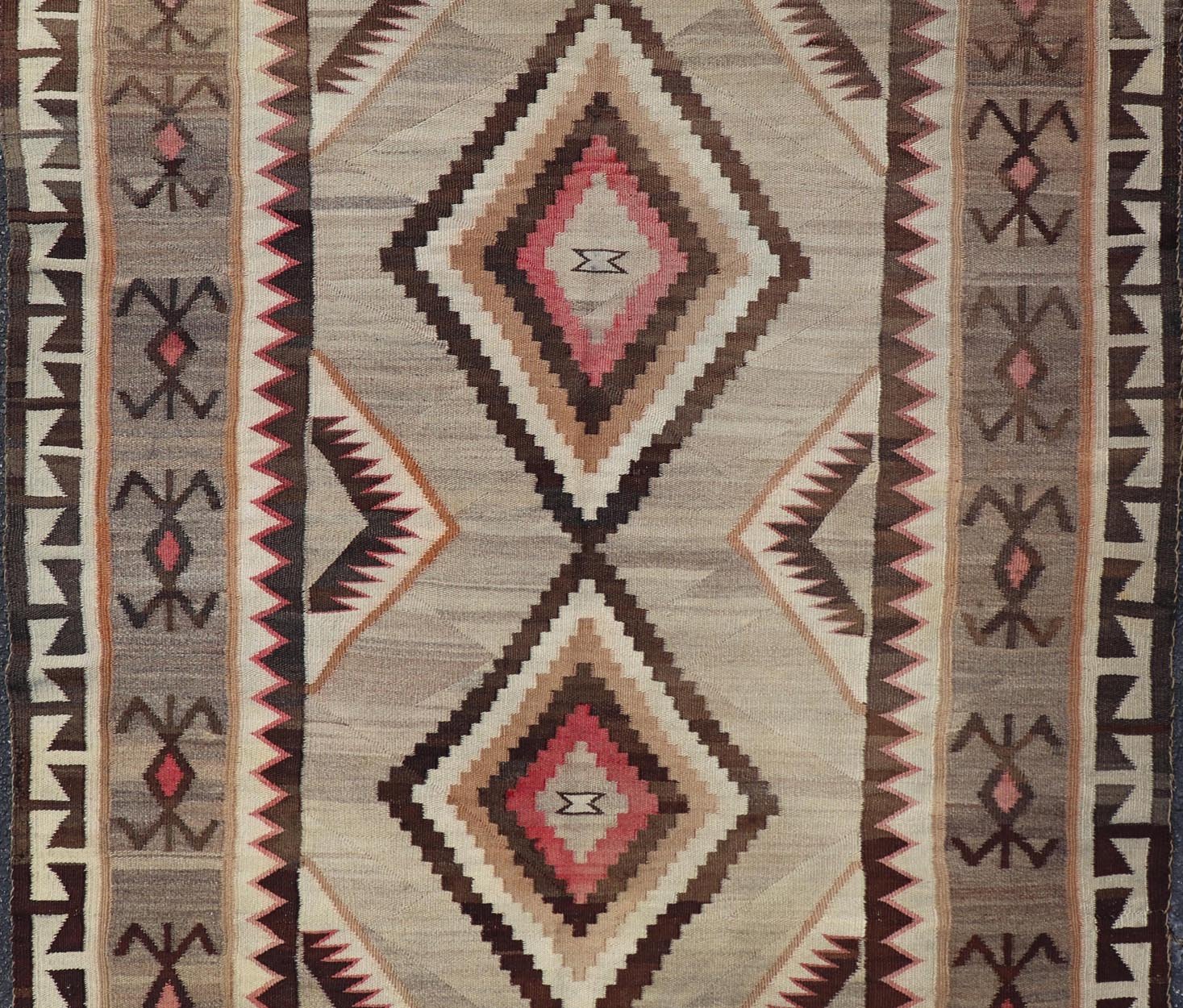 Vintage Large hand Woven Navajo Rug in Gray, Ivory, Black, Brown's, and Red. Keivan Woven Arts rug X23 - 0107, country of origin / type: America / Navajo, circa 1930 Measures: 4'4 x 6'3 This intriguing vintage Navajo rug was woven in the Navajo ar... - Keivan Woven ArtsX23 - 0107 - 23524Rug