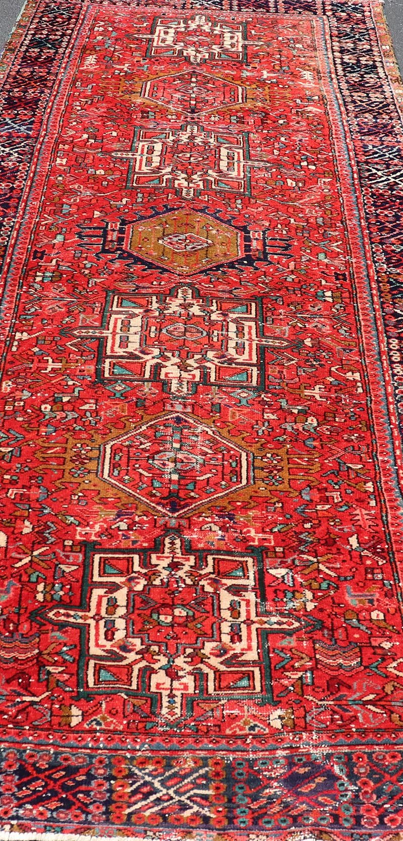 Vintage Persian Karajeh - Heriz Gallery with Geometric Medallions On A Red Ground. Keivan Woven Arts , rug X23 - 0109, country of origin / type: Persian / Heriz - Karajeh, circa mid - 20th century. Measures: 5'0 x 12'4 This gallery rug incorporates a di... - Keivan Woven ArtsX23 - 0109 - 24354Rug