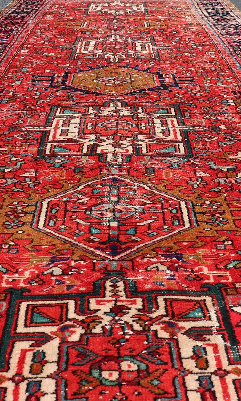 Vintage Persian Karajeh - Heriz Gallery with Geometric Medallions On A Red Ground. Keivan Woven Arts , rug X23 - 0109, country of origin / type: Persian / Heriz - Karajeh, circa mid - 20th century. Measures: 5'0 x 12'4 This gallery rug incorporates a di... - Keivan Woven ArtsX23 - 0109 - 24354Rug