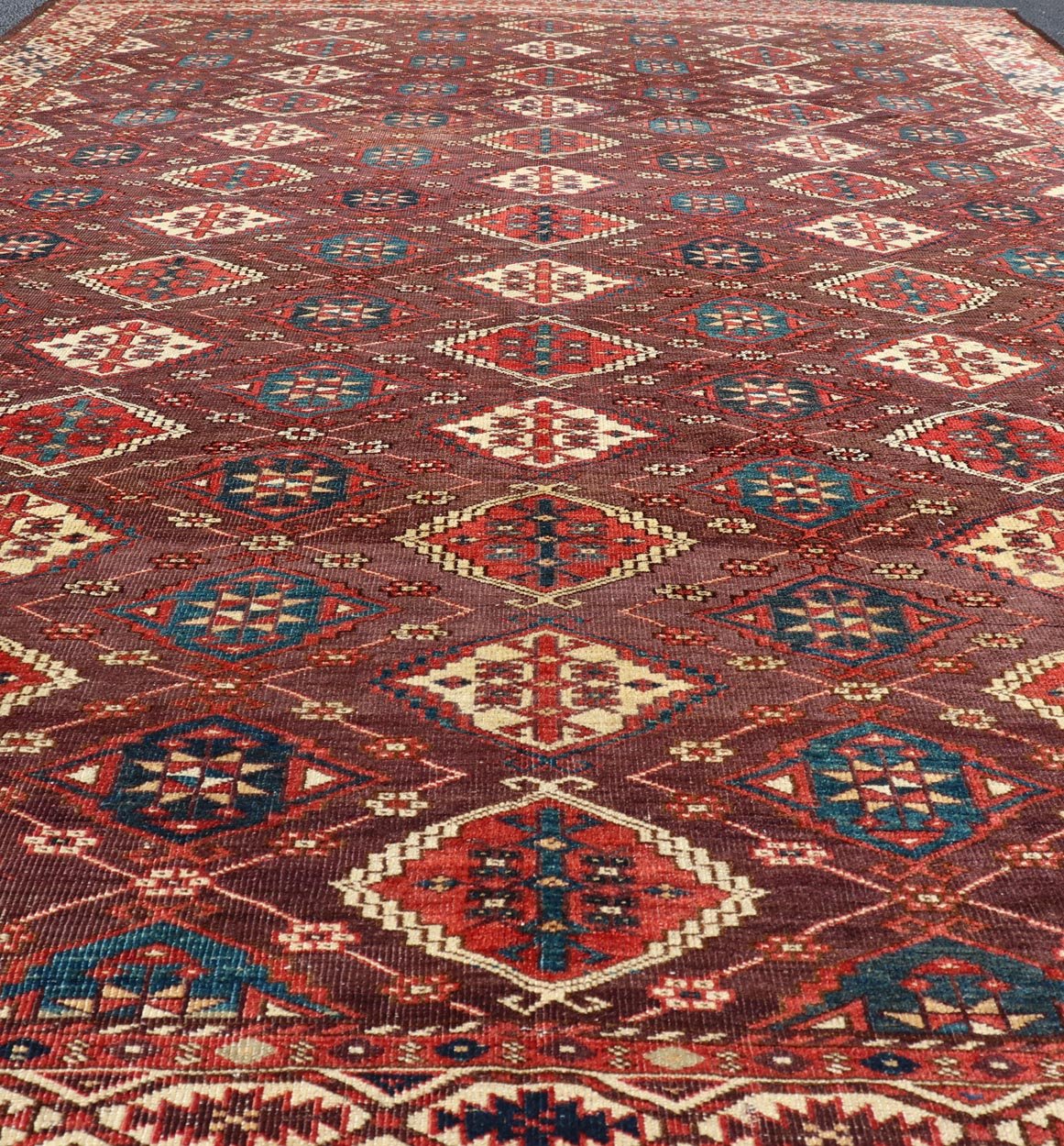 Early 19th century Chodor main carpet from Turkmenistan Antique Turkomen Rug in Wool with Repeating Gul Design in Brown, Blue, and Red. Keivan Woven Arts; rug X23 - 0306 - 201, country of origin / type: Turkestan / Turkomen circa 1820s. Measure... - Keivan Woven ArtsX23 - 0306 - 201 - 23547Rug
