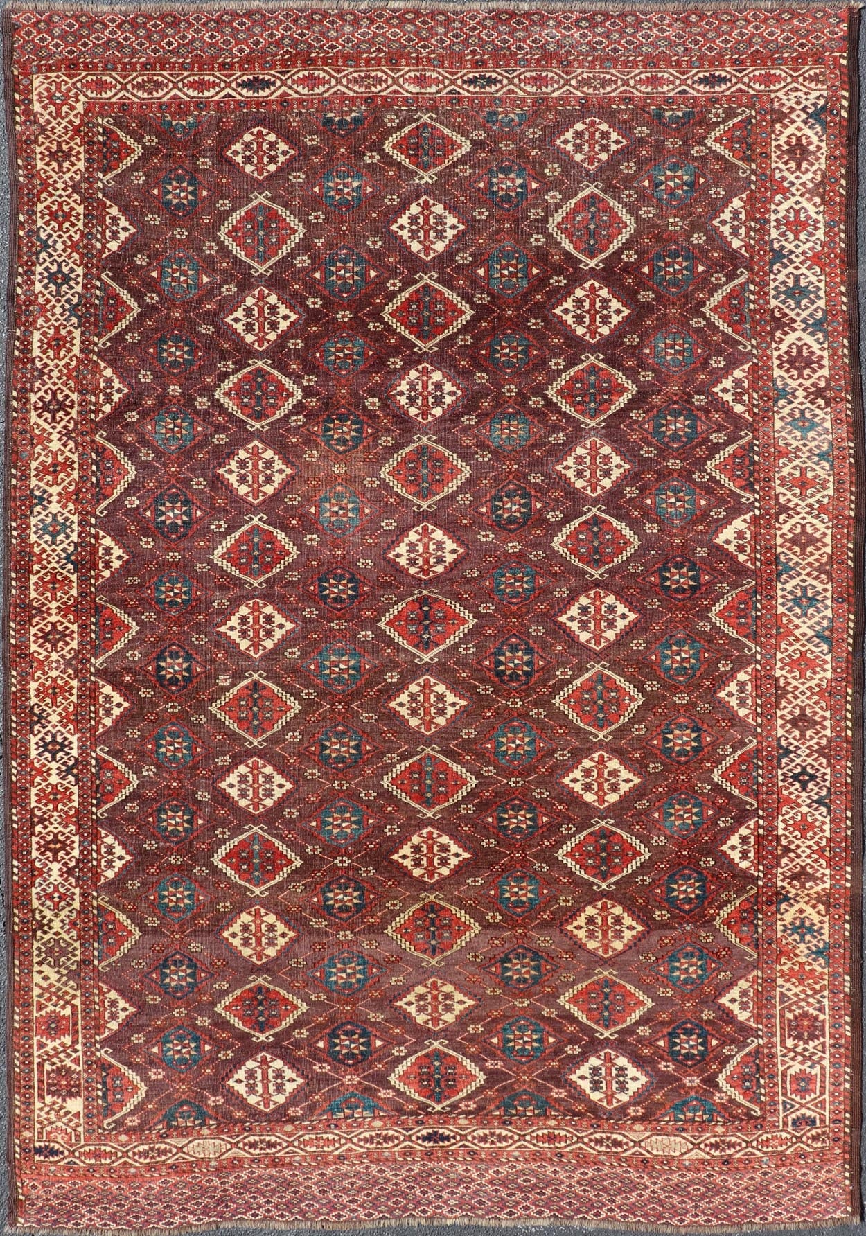 Early 19th century Chodor main carpet from Turkmenistan Antique Turkomen Rug in Wool with Repeating Gul Design in Brown, Blue, and Red. Keivan Woven Arts; rug X23 - 0306 - 201, country of origin / type: Turkestan / Turkomen circa 1820s. Measure... - Keivan Woven ArtsX23 - 0306 - 201 - 23547Rug