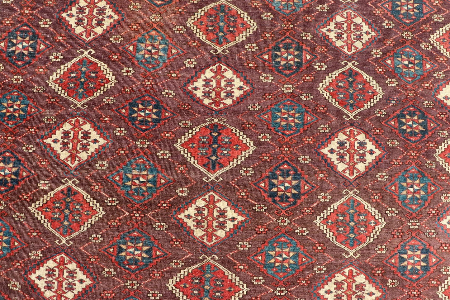 Early 19th century Chodor main carpet from Turkmenistan Antique Turkomen Rug in Wool with Repeating Gul Design in Brown, Blue, and Red. Keivan Woven Arts; rug X23 - 0306 - 201, country of origin / type: Turkestan / Turkomen circa 1820s. Measure... - Keivan Woven ArtsX23 - 0306 - 201 - 23547Rug