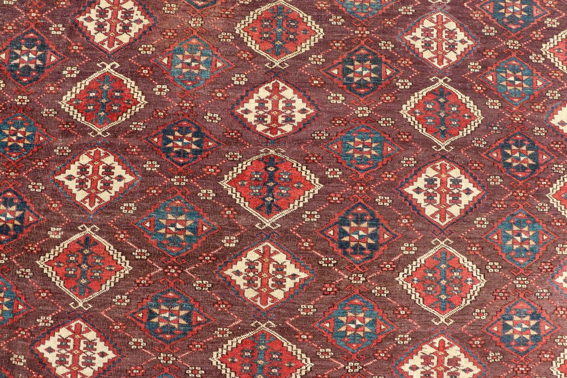 Early 19th century Chodor main carpet from Turkmenistan Antique Turkomen Rug in Wool with Repeating Gul Design in Brown, Blue, and Red. Keivan Woven Arts; rug X23 - 0306 - 201, country of origin / type: Turkestan / Turkomen circa 1820s. Measure... - Keivan Woven ArtsX23 - 0306 - 201 - 23547Rug
