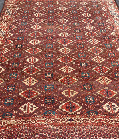 Early 19th century Chodor main carpet from Turkmenistan Antique Turkomen Rug in Wool with Repeating Gul Design in Brown, Blue, and Red. Keivan Woven Arts; rug X23 - 0306 - 201, country of origin / type: Turkestan / Turkomen circa 1820s. Measure... - Keivan Woven ArtsX23 - 0306 - 201 - 23547Rug