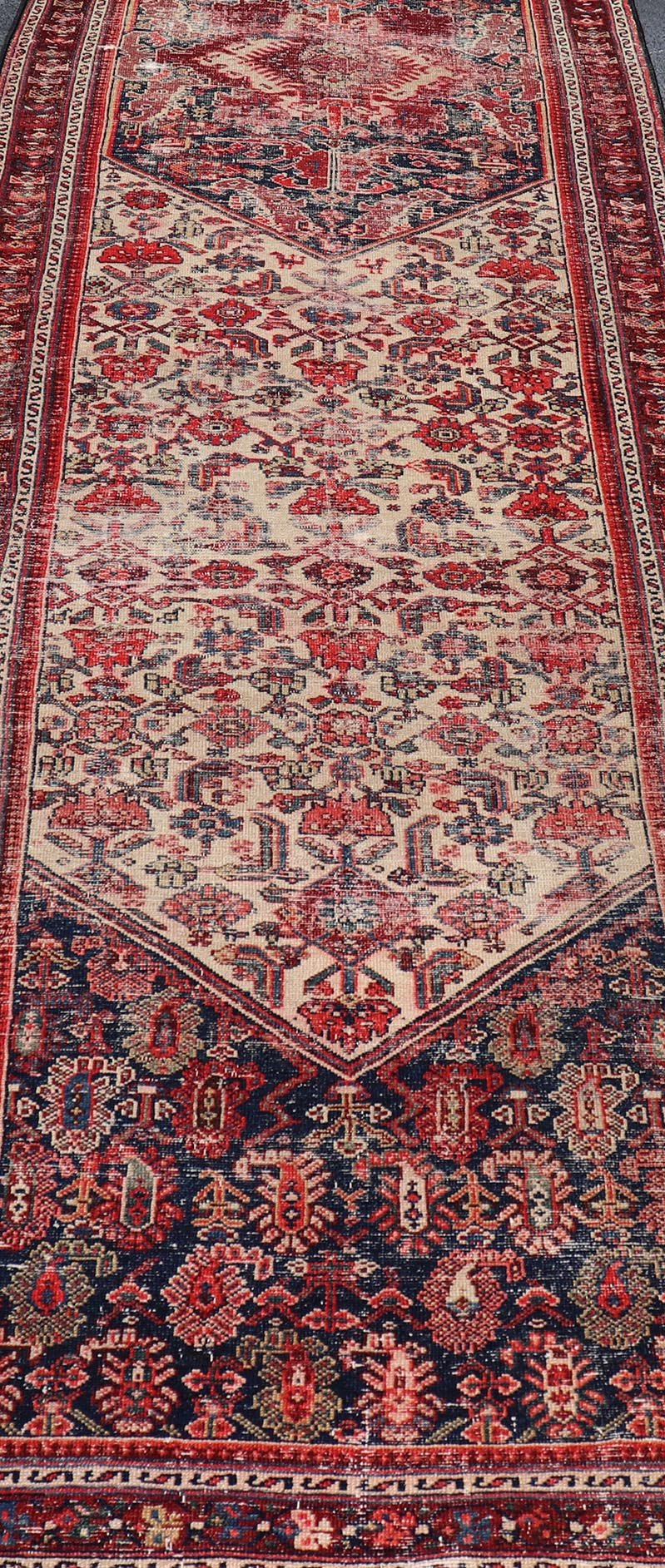 Antique Persian Long Hamedan Runner With Medallions in Ivory and Maroon. Keivan Woven Arts / rug X23 - 0402 - 180, country of origin / type: Iran / Hamadan, circa 1910 Measures: 3'5 x 26'4 This antique Persian hamadan runner, from western Persia, or... - Keivan Woven ArtsX23 - 0402 - 180 - 24265Rug