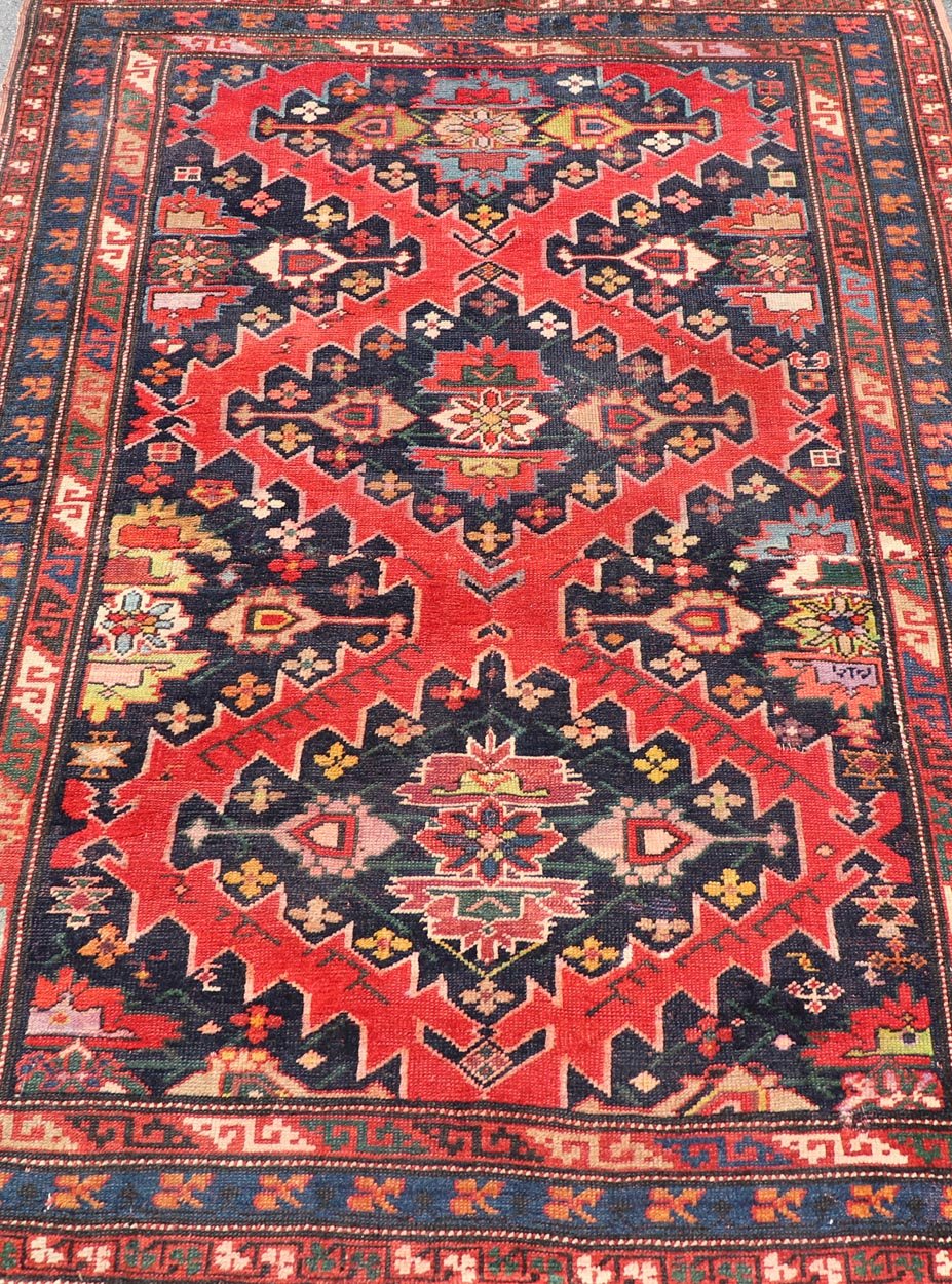Antique Caucasian Kazak Rug with Sub - Geometric Medallions Design in Red and Blue. Keivan Woven Arts / rug X23 - 0405 - 259, country of origin / type: Caucasus / Kazak, circa Late - 19th Century. Antique Caucasian Kazak Rug with Sub - Geometric Medallions Desig... - Keivan Woven ArtsX23 - 0405 - 259 - 24283Rug