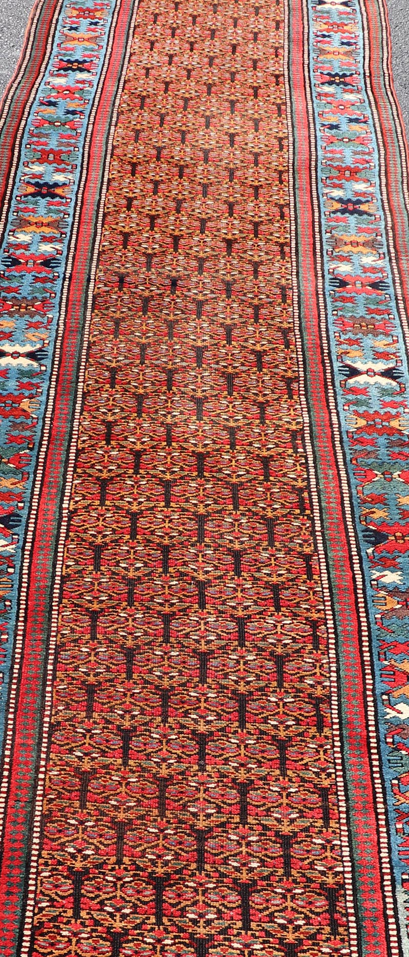 Antique Persian Kurdish Long Gallery Runner with Repeating Tribal Motif Design. Keivan Woven Arts; rug X23 - 0816 - 335; country of origin / type: Persian / Kurdish circa 1900. Measures: 3'5 x 14'9 This antique hand - knotted Persian Kurdish wide runn... - Keivan Woven ArtsX23 - 0816 - 335 - 24862Rug