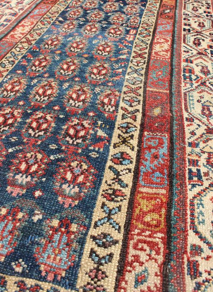Long Antique Persian Runner - This antique runner was woven in far northwest Persia in the area bordering the Caucasus. The deep madder red color and saturation of its finely drawn elements are enhanced by their placement against a deep indigo field. Th... - Keivan Woven ArtsZBH - 15053 - 8006Rug