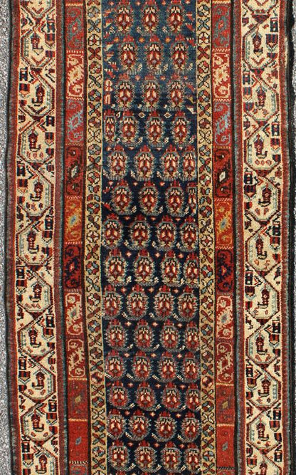 Long Antique Persian Runner - This antique runner was woven in far northwest Persia in the area bordering the Caucasus. The deep madder red color and saturation of its finely drawn elements are enhanced by their placement against a deep indigo field. Th... - Keivan Woven ArtsZBH - 15053 - 8006Rug
