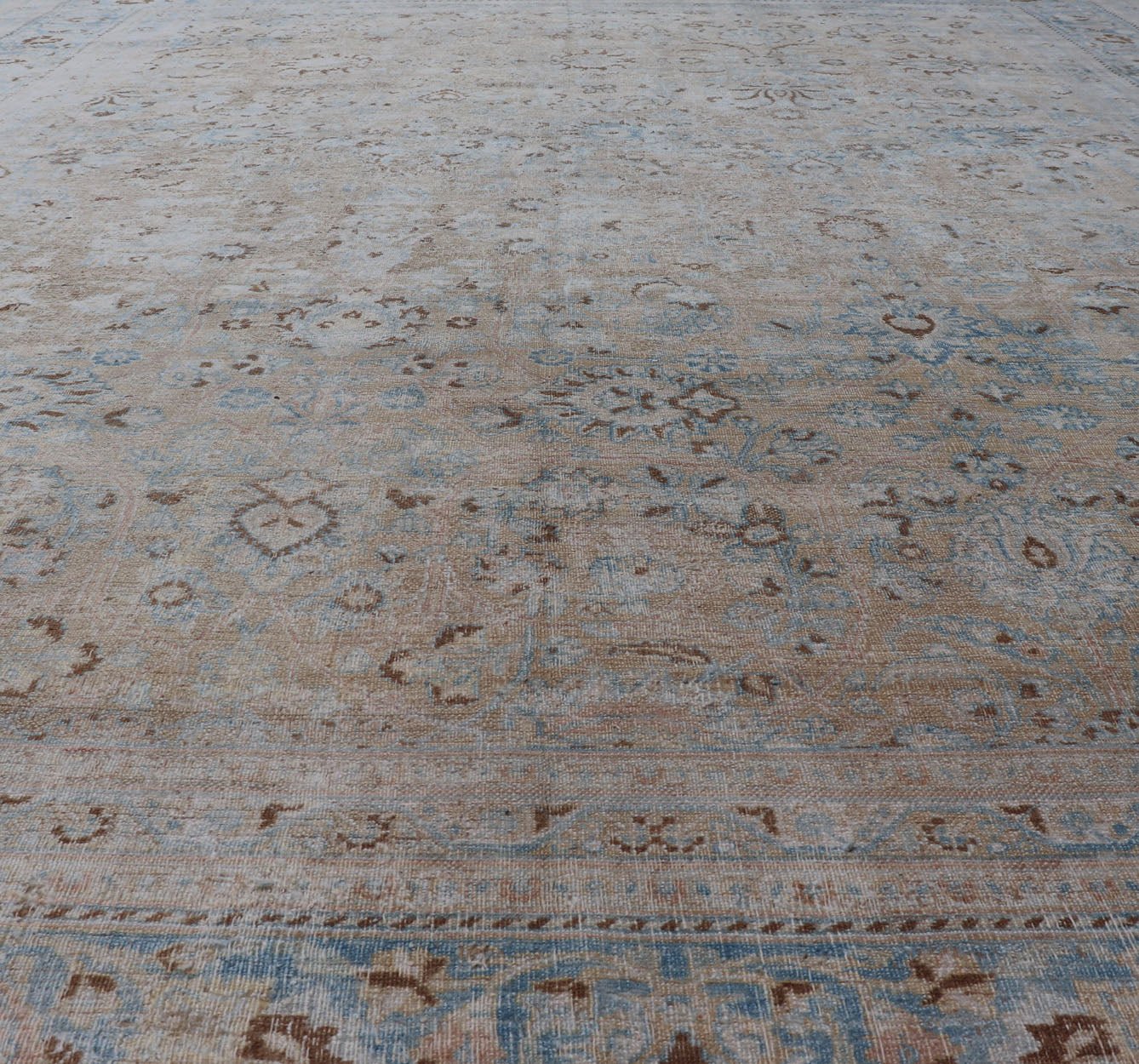 Persian distressed Antique Mashhad Carpet with Muted Floral and Medallion Design. Antique distressed Persian Mashhad carpet with tan and blue floral and medallion design, / ZIR - 51 - KV - 10. Persian Mashhad floral design. This outstanding mu... - Keivan Woven ArtsZIR - 51 - KV - 10 - 14994Rug