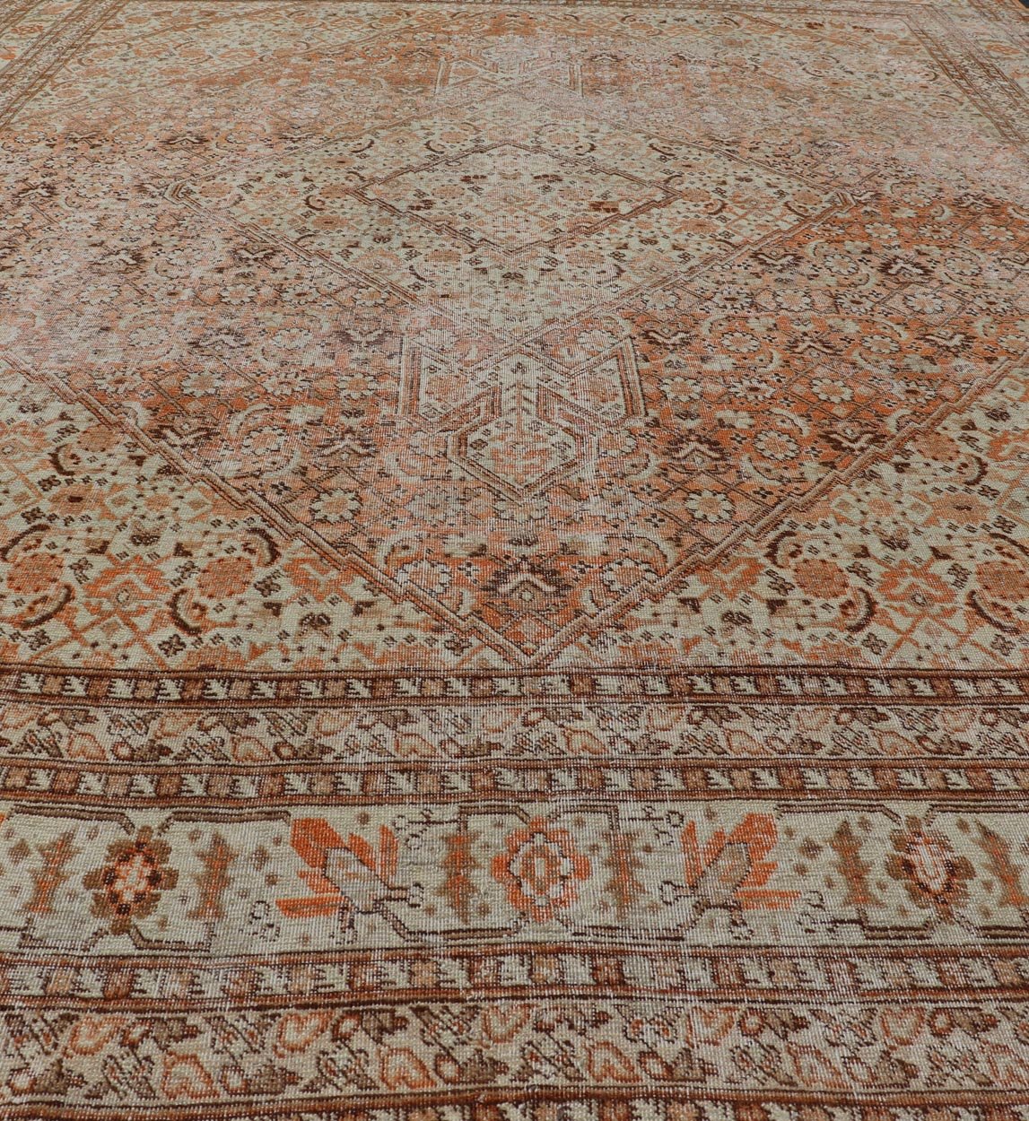 Antique Persian Tabriz with All - Over Medallion Design in Orange and Browns This antique Persian Tabriz rug features an all - over, sub - geometric floral design rendered in off white, orange and brown tones. A complementary, multi - tiered border enco... - Keivan Woven ArtsZIR - 66 - KV - 12 - 15060